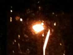 Next photo of faux moon through rain, the streetlamp in the back lane