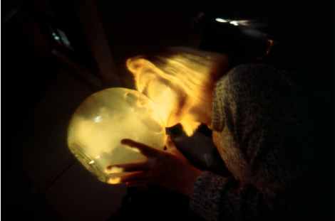 Kayla blowing into glass bowl, 35mm slide taken by Lesley Bricknell at Plymouth Arts Centre