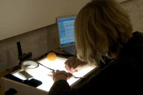 Kayla working in Studio One, engraving 16mm filmstrip on lightbox