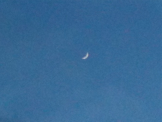new crescent moon in blank sky, a few seconds later